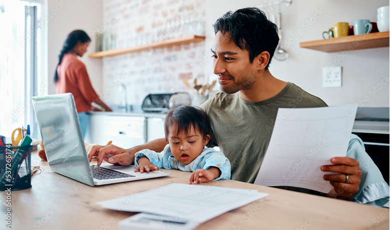 man with child looking at laptop