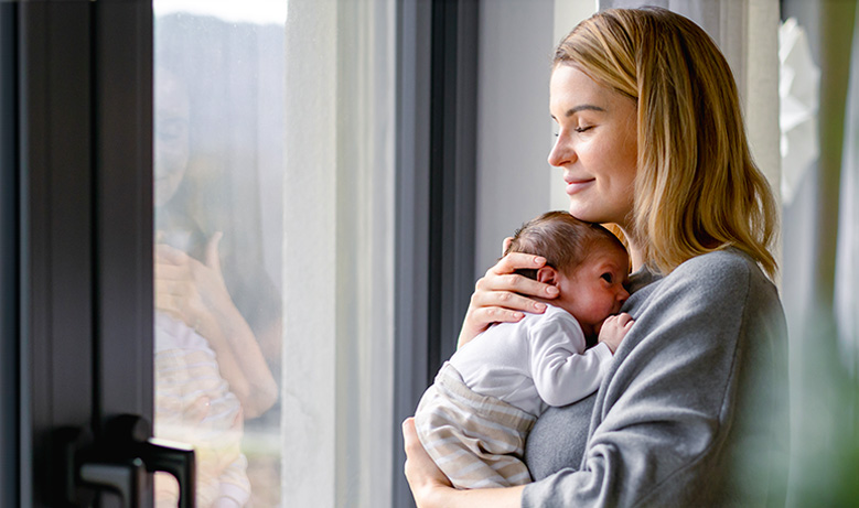 person holding newborn