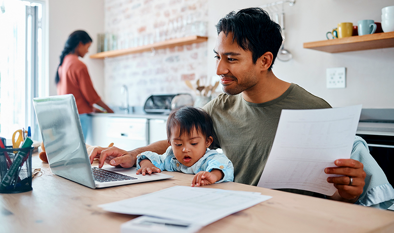 Person with baby in lap at the computer