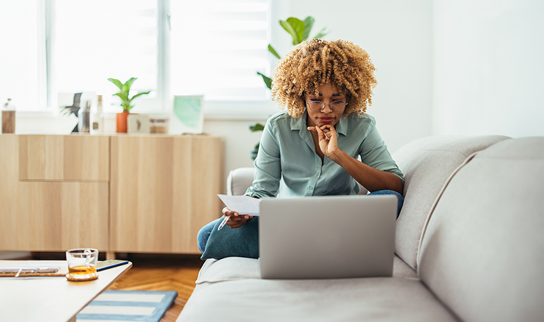 person on computer sitting on couch