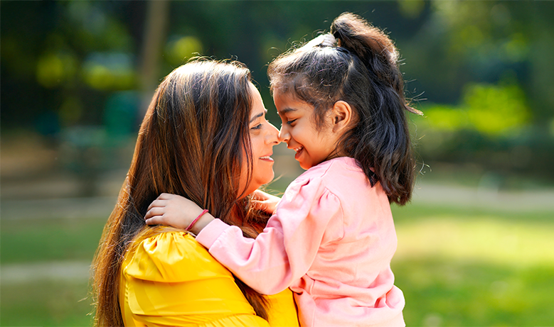 woman holding smiling young girl