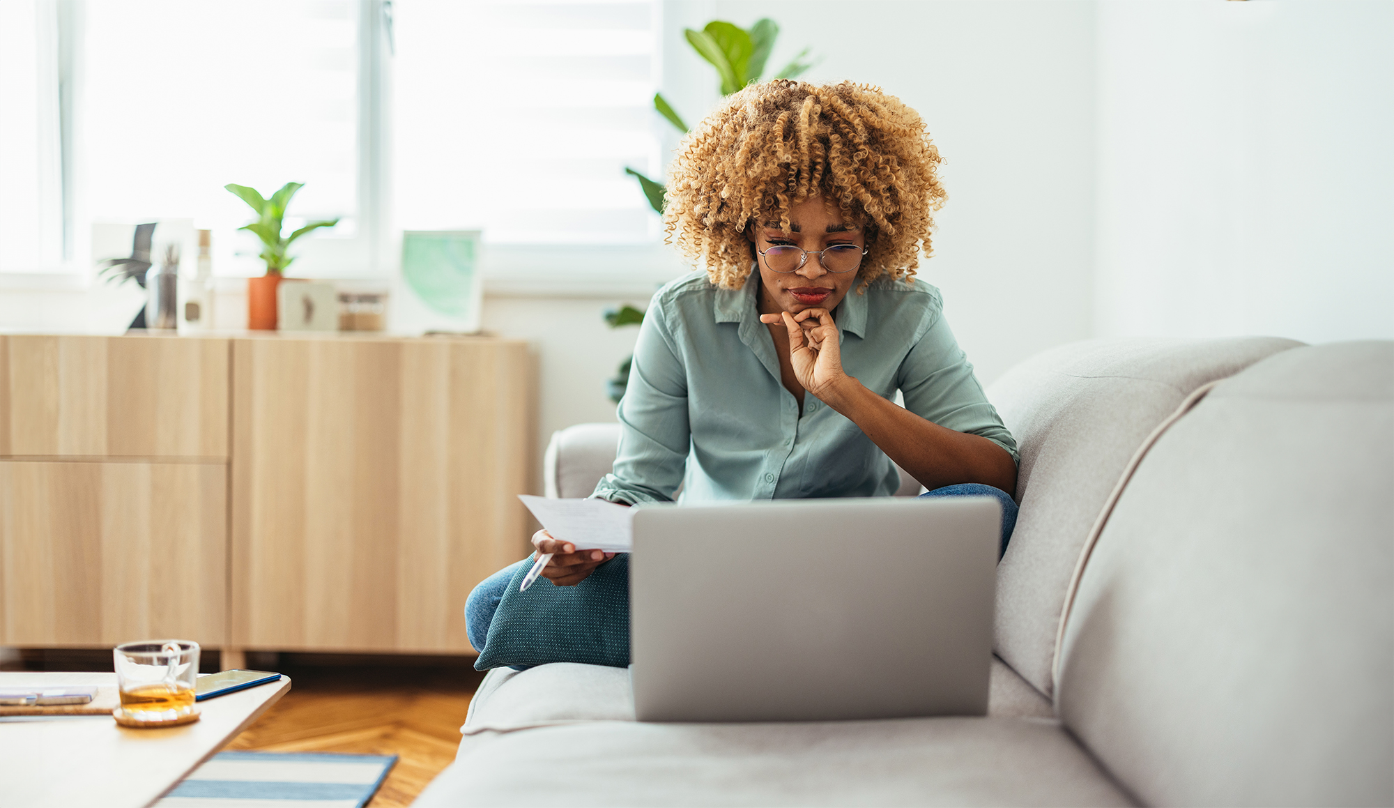 person looking at computer on couch