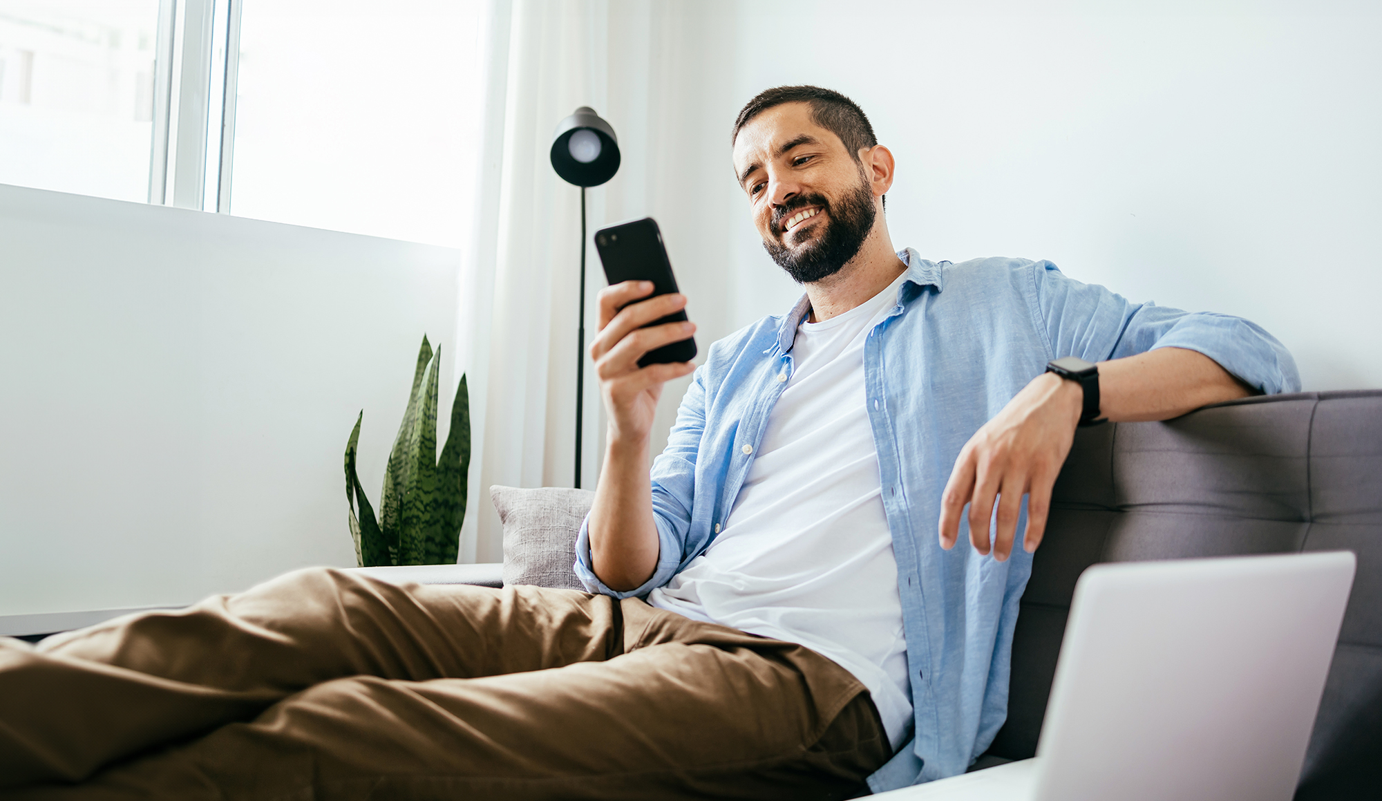 person looking at phone on couch