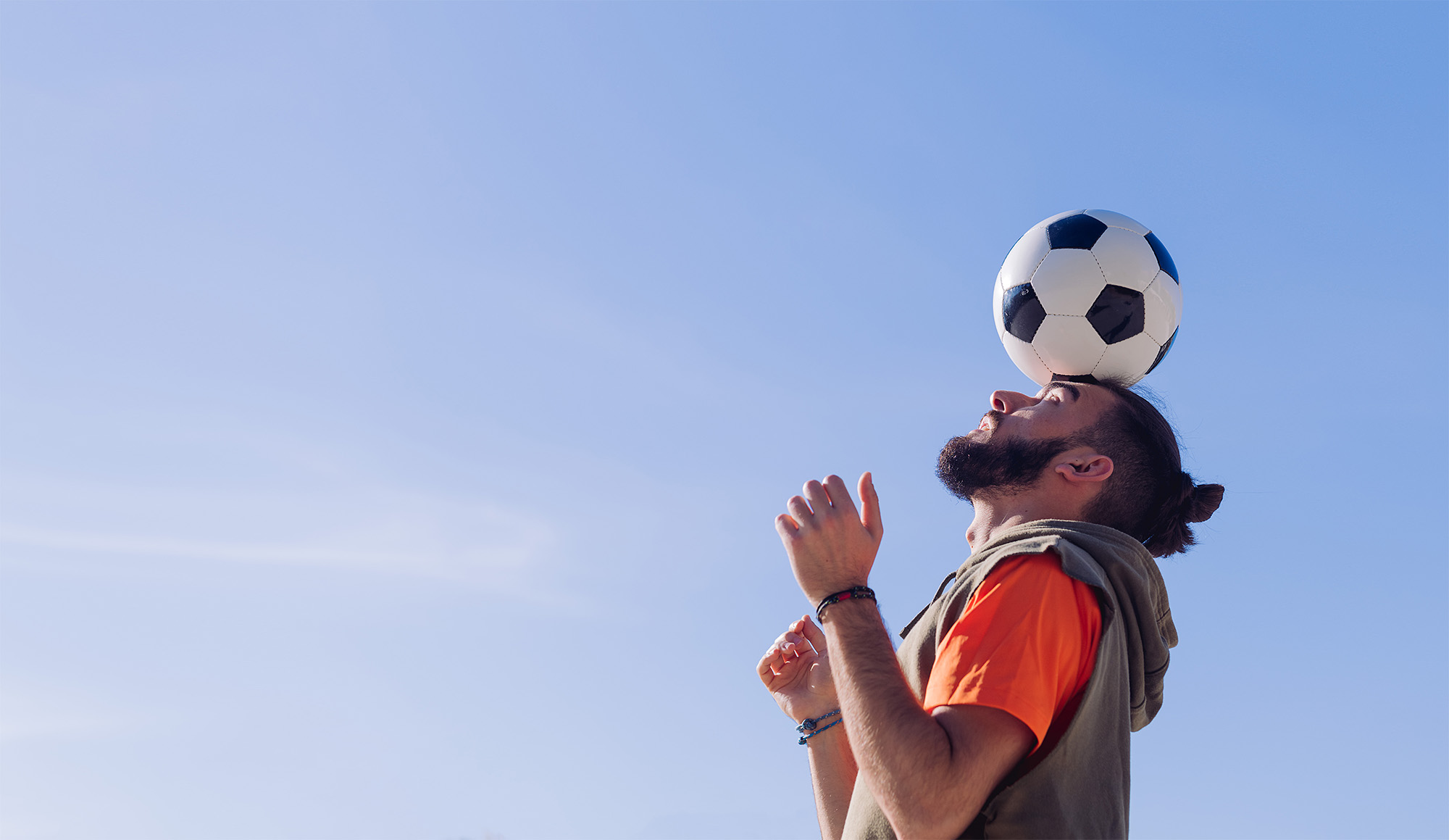 soccer ball balanced on forehead
