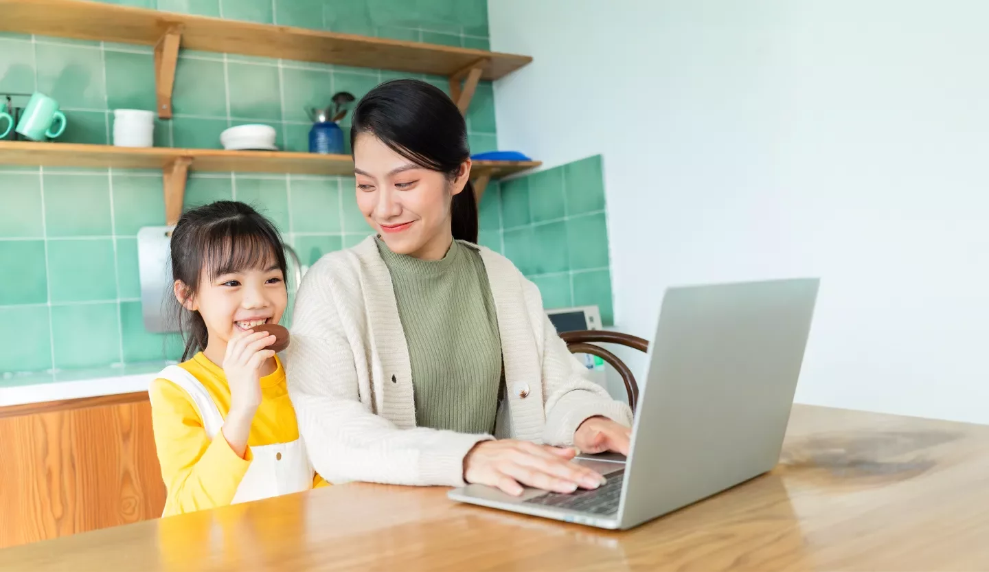 person with child and laptop