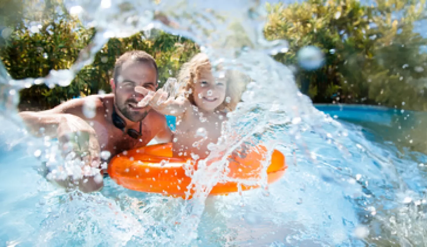 father with child on raft