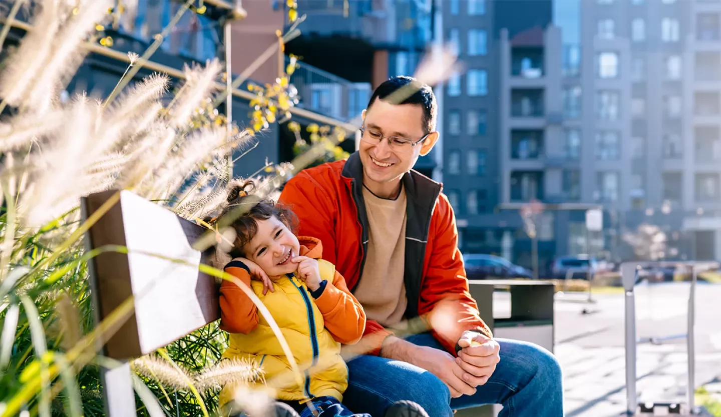 person on bench with child