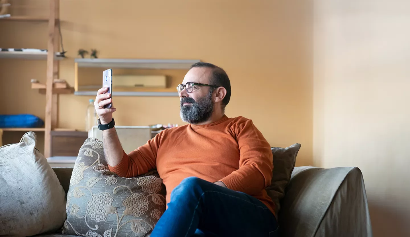 person on phone on couch